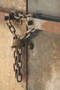 Rusty Chain with Lock on old Metal Double Doors Royalty Free Stock Photo