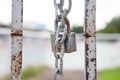 Rusty chain and master key locked on grunge iron gate Royalty Free Stock Photo