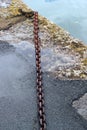 Rusty chain on a quay side.