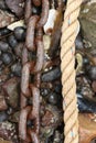 Rusty Chain and Rope on Pebble Beach Royalty Free Stock Photo