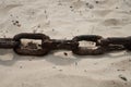 Rusty chain in the sand on the beach Royalty Free Stock Photo