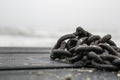 Rusty chain on wooden beach bridge Royalty Free Stock Photo
