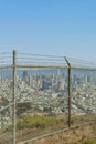 rusty chainlink fence with downtown and ocean background