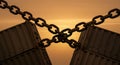 Rusty chains connect cargo containers under orange sky Royalty Free Stock Photo