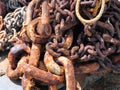 Rusty chains for mooring fishing boats in the harbor of Porthleven Cornwall England