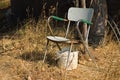 A rusty chair and a white plastic bucket abandoned in a field Umbria, Italy