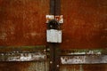 Rusty closed doors with old fashioned padlock