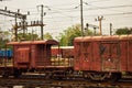 A rusty coloured Indian goods train guards compartment tied with goods train