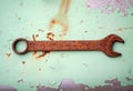 Rusty combination wrench. An old wrench covered with corrosion lies on a metal surface Royalty Free Stock Photo