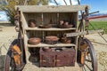 Rusty cooking utensils on shelves in the back of an antique covered wagon Royalty Free Stock Photo