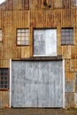 Rusty corrugated metal wall, with windows and doors Royalty Free Stock Photo