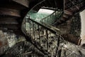 Rusty decorated vintage spiral staircase in abandoned mansion