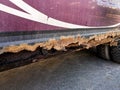 Rusty and dirty car threshold damaged by corrosion. Hole in the threshold Royalty Free Stock Photo