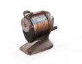 A rusty dirty old vintage antique vacuum mounted hand powered pencil sharpener isolated on white with room 3d render