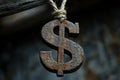 Rusty dollar sign hanging from a rope, representing economic decline or loss Royalty Free Stock Photo