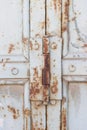 Rusty door hinge with rust, crack and old loose white paint texture Royalty Free Stock Photo