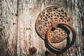 Rusty door knocker and old wooden door