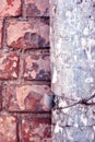 Rusty drain pipe with coiled wire on red brick wall close up detail Royalty Free Stock Photo
