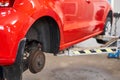 Rusty drum brakes, rear on red car. Change the old to new brake disc on car in a garage. Auto mechanic repairing