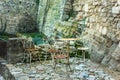 Rusty empty old table and chairs on stone medieval terrasse in one of the most beautiful village of France Lacoste in Vaucluse, Royalty Free Stock Photo