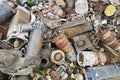 Rusty engines stacked in the scrapyard. Engine parts greased and covered with rust. Dump of pieces of iron and wrecking machinery