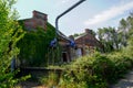 Rusty factory disused abandoned industrial wasteland overgrown with vegetation in France