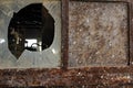 Rusty factory door and smashed glass