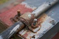 rusty fastening on bolts fastens the pipe, old rusty bolted clamp fastening the plastic pipe Royalty Free Stock Photo