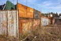 Rusty fence with barbed wire in the industrial zone