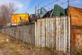 Rusty fence with barbed wire in the industrial zone