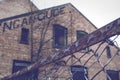 Rusty fence in front of old brick building