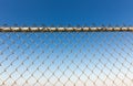 Rusty fence rabitz on the background of sky.