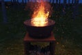 Rusty fire bowl with big fire and sparks at night Royalty Free Stock Photo