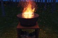 Rusty fire bowl with big fire and sparks at night