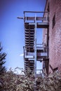 Rusty fire escape of derelict red brick building Royalty Free Stock Photo