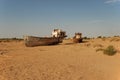 Rusty fishing boats lying in the sand Royalty Free Stock Photo