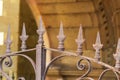 Rusty forged iron fence with spikes and peaks of an antique medieval castle