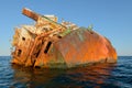 Rusty frame of a stranded naval ship in the middle of the sea Royalty Free Stock Photo