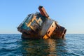 rusty frame of a stranded naval ship in the middle of the sea Royalty Free Stock Photo