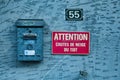 Rusty french mail box and sign warning for snow Royalty Free Stock Photo