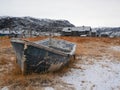 A rusty frozen fishing boat. Old fishing village on the shore of the Barents sea Royalty Free Stock Photo