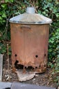 Rusty garden incinerator on home allotment for burning green waste stock photo