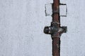 Rusty gas pipe installed in white wall outdoors, space for text Royalty Free Stock Photo