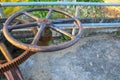 Rusty gear toothed wheels old water valve select focus with shallow depth of field