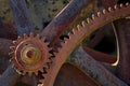 Rusty gears, some of which have dust or cobwebs hanging on them, against a dark background Royalty Free Stock Photo