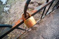 Rusty gold padlock on the fence