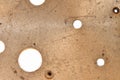 Rusty golden copper old surface with holes for grunge wallpaper or background