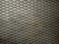 Rusty gray metal texture with a diagonal mesh. Shallow grid of steel wall texture. Speaker grill texture.Background for grunge Royalty Free Stock Photo