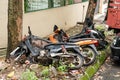 A rusty half-destroyed bike is lying on the lawn. Landfill of old transport in the city