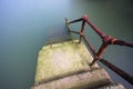 Rusty handrail going down on water Royalty Free Stock Photo